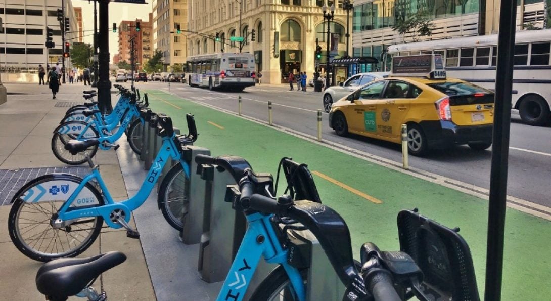 Bikes parked near a bike lane on a busy street