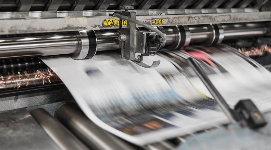 A periodical being printed by a printing press