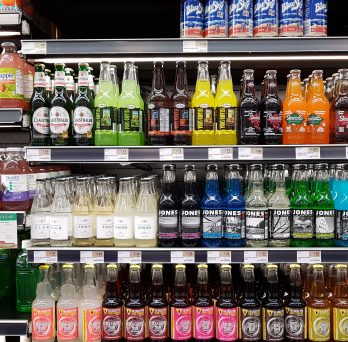 Beverages on a shelf in a retail store
                  